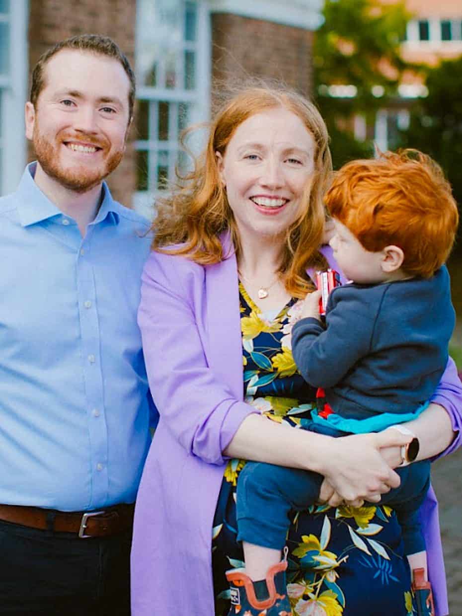 Xander and Melody with their son, standing in front of Redeemer Church, Beeston.